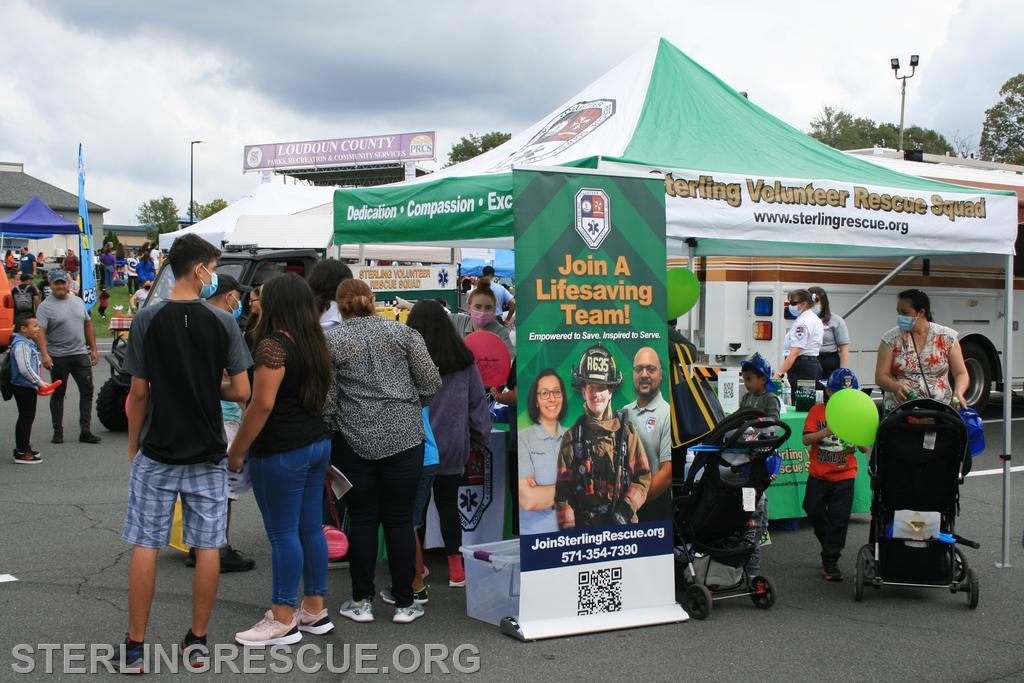 Group of people outside by a recruitment tent for Sterling Rescue