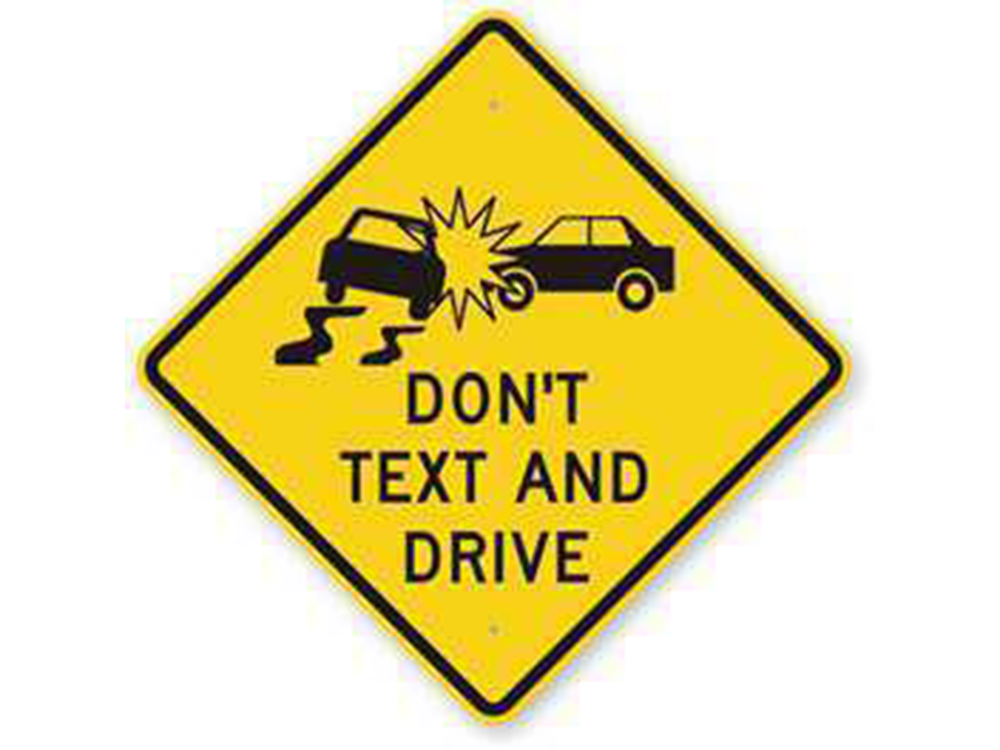 Yellow street sign that says Don't text and Drive with two cars crashed