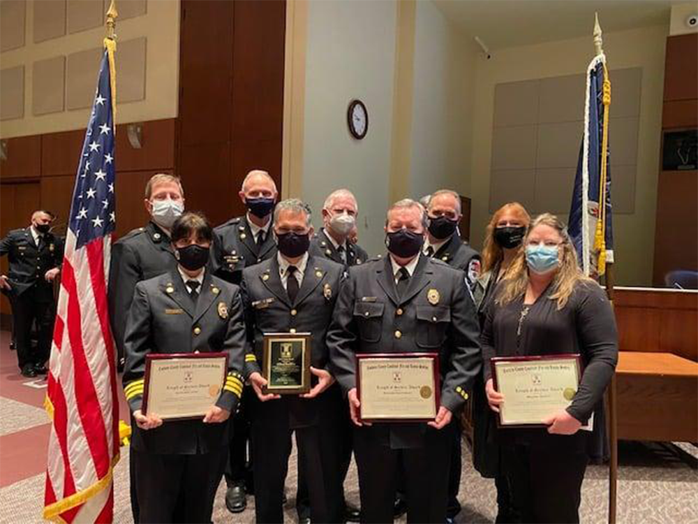 Firefighters standing with awards
